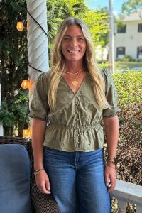 Courtney Hogan, LMFT, Senior Clinician at Blueprint Mental Health, standing outdoors and smiling.
